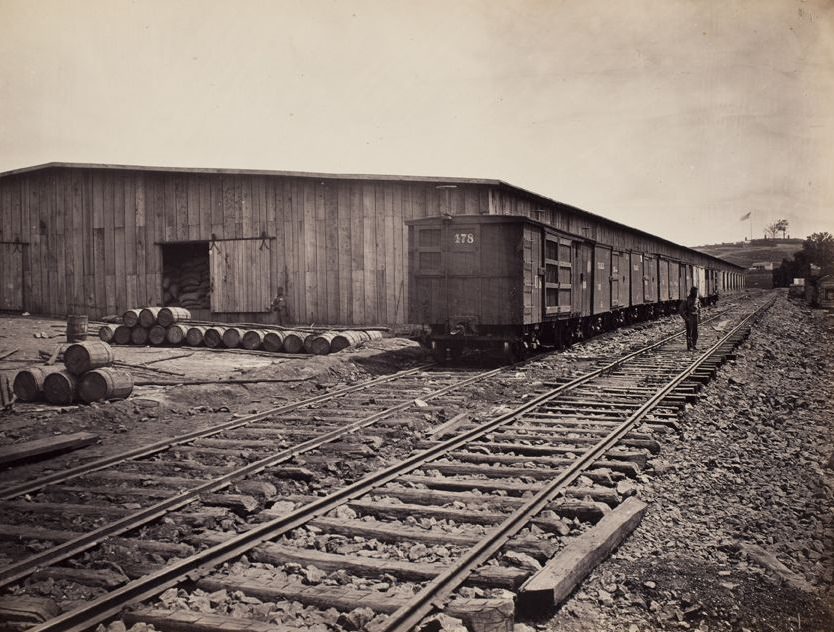 Railroad cars and warehouses in a railroad yard, 1865