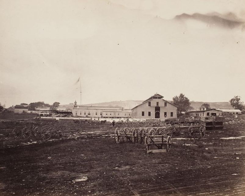 Wagons and wagon wheel sets outside a wagon repair shop, 1865