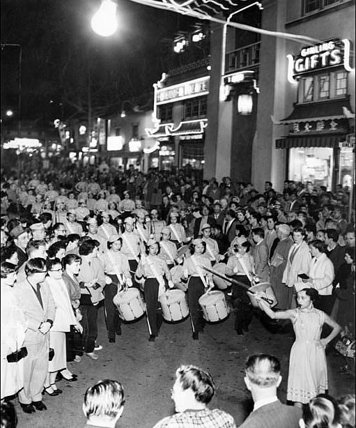 The Chung Wah Chinese School Drum and Bugle Corps performs in the Chinese New Year parade in Los Angeles' Chinatown, 1955.