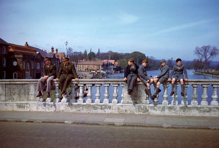 Troops and civilians pass the time on the River Thames in the spring of 1944