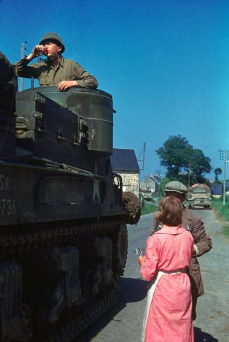 A French couple shares cognac with an American tank crew, northern France, summer 1944