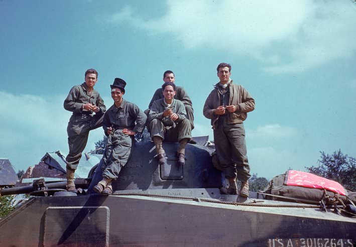 An American tank crew takes a breather on the way through the town of Avranches, Normandy, summer 1944