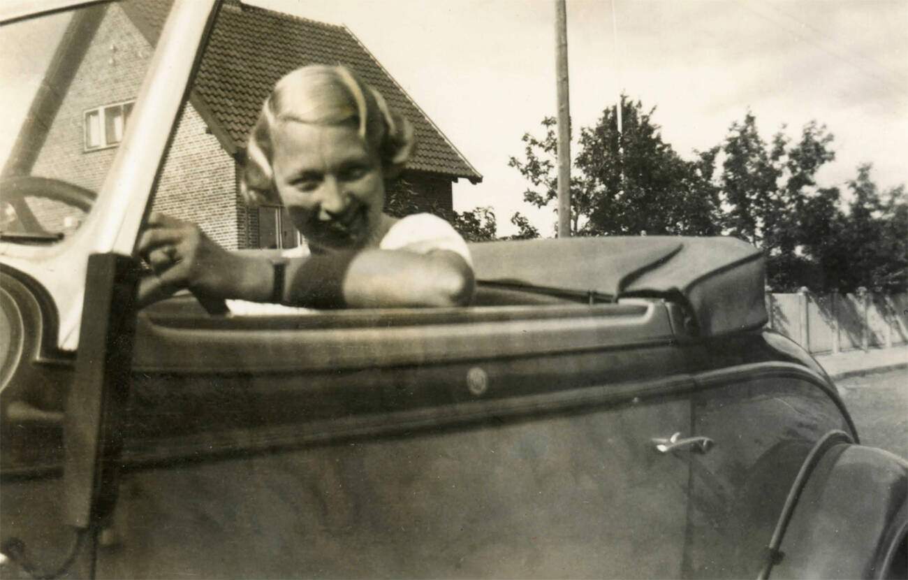 Woman driving a Pontiac convertible, Denmark