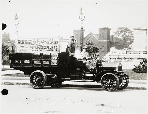 Rapid 4 cylinder truck with driver and two passengers.