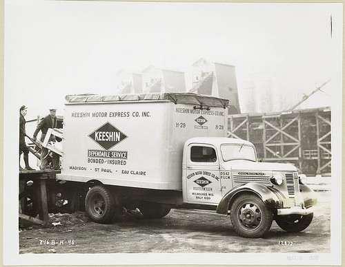 Model T-16 B-K-46 Men loading furniture in Keeshin Motor Express Co. Inc. truck.