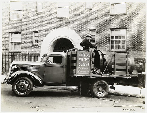 Model T 16A - G12 Men working from the truck for A.C. Meyers Welding Service.