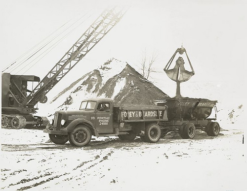 Pontiac truck loading sand.