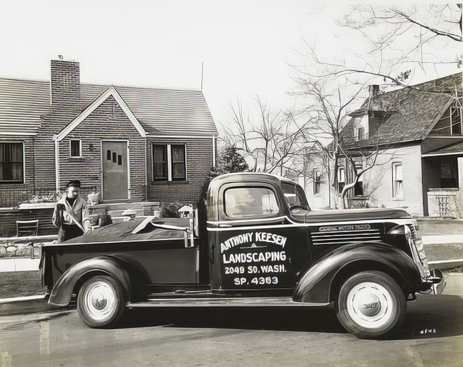 GM truck filled with soil for landscaping in front of a house.