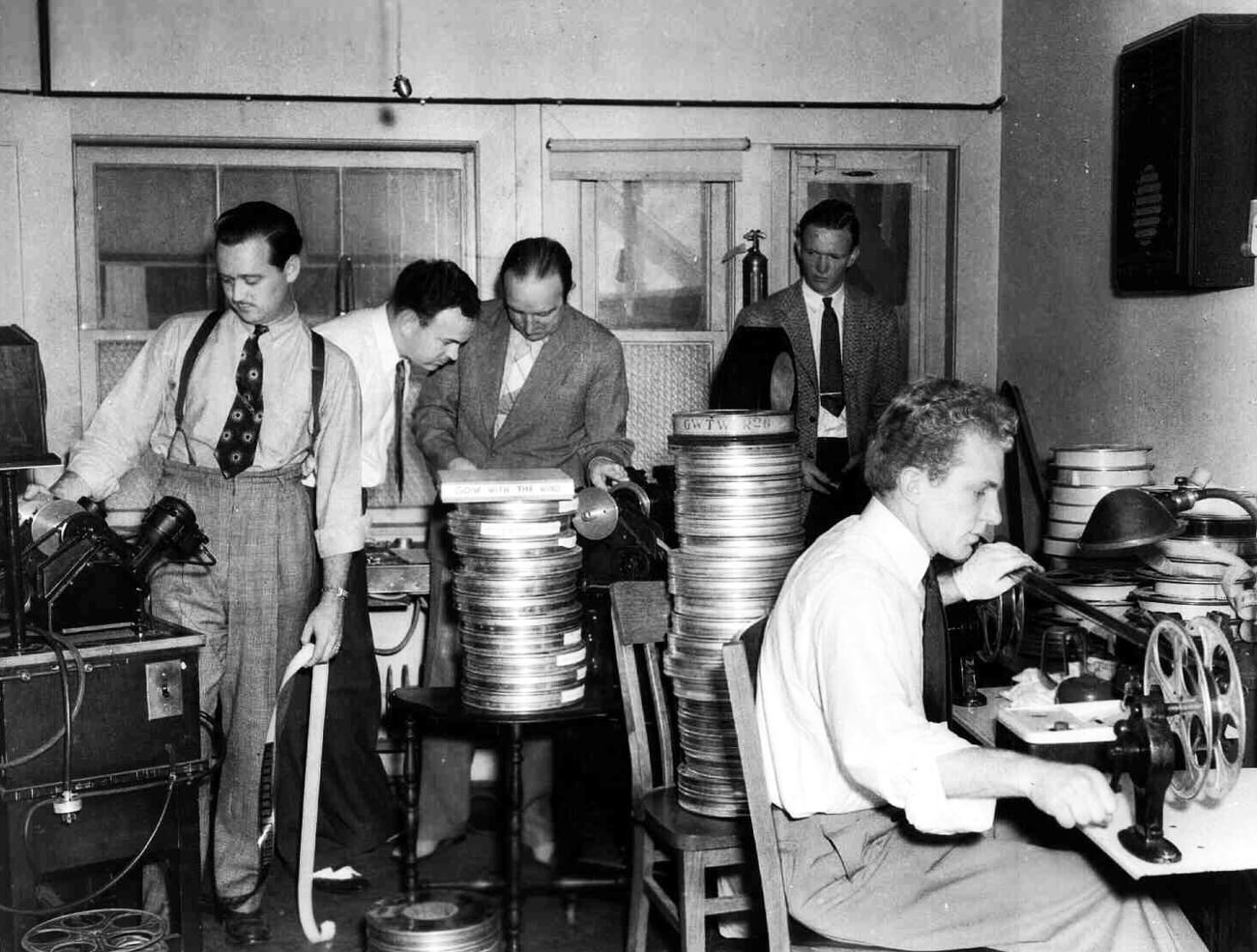 Film Editor Hal C. Kern, third from left, and others, edit Gone with the Wind in 1939.