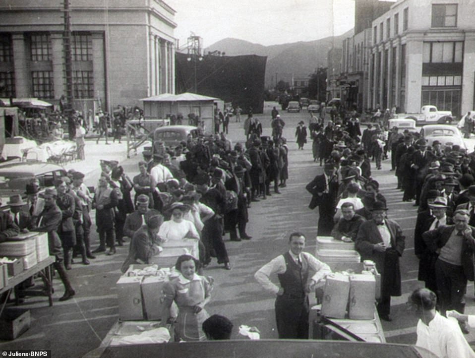 Extras on set lining up to receive lunch during the shooting of one of the film's scenes.