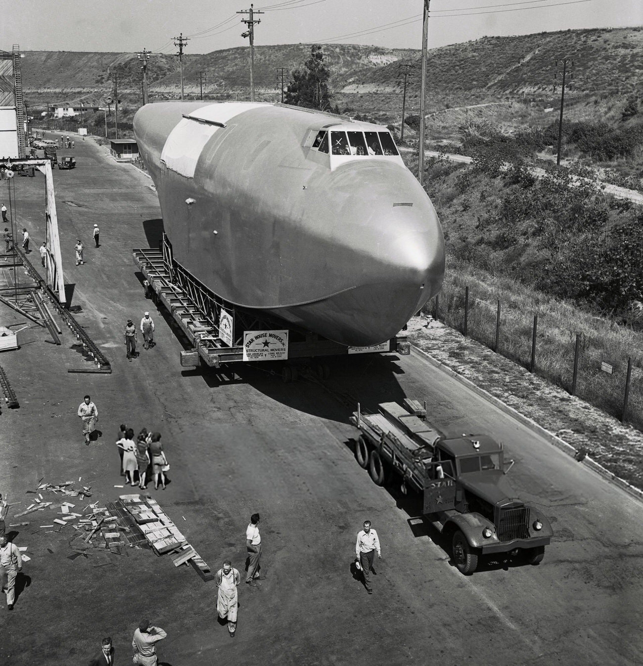 The fuselage of Howard Hughes' Spruce Goose leaving the hangar, 1940s.