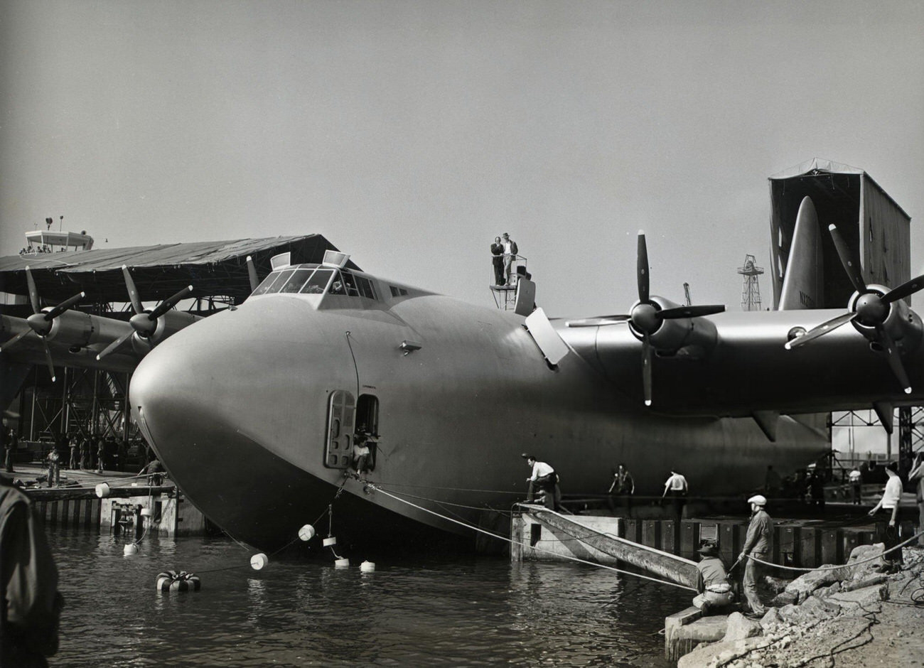 Howard Hughes supervising the launch of his flying boat, 1940s.