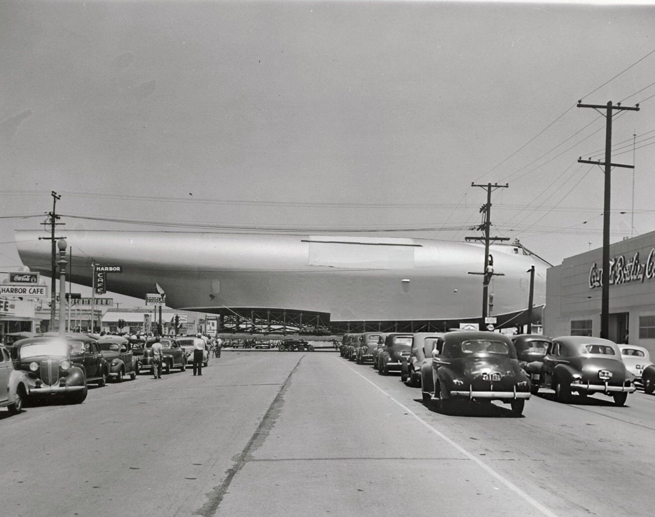 The Spruce Goose being transported across a highway intersection, 1940s.