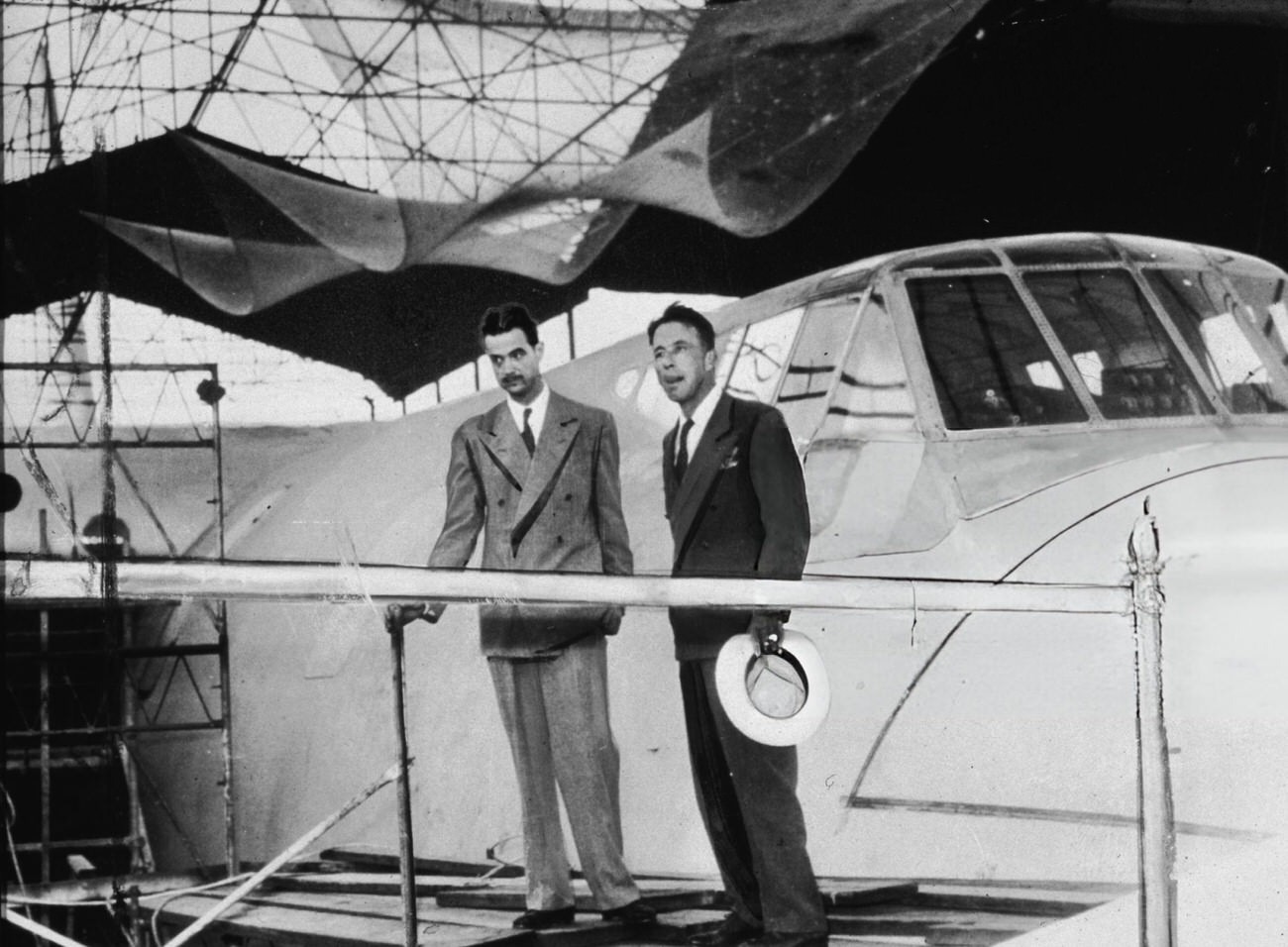 Howard Hughes and an unidentified man near the Spruce Goose's cockpit, 1947.