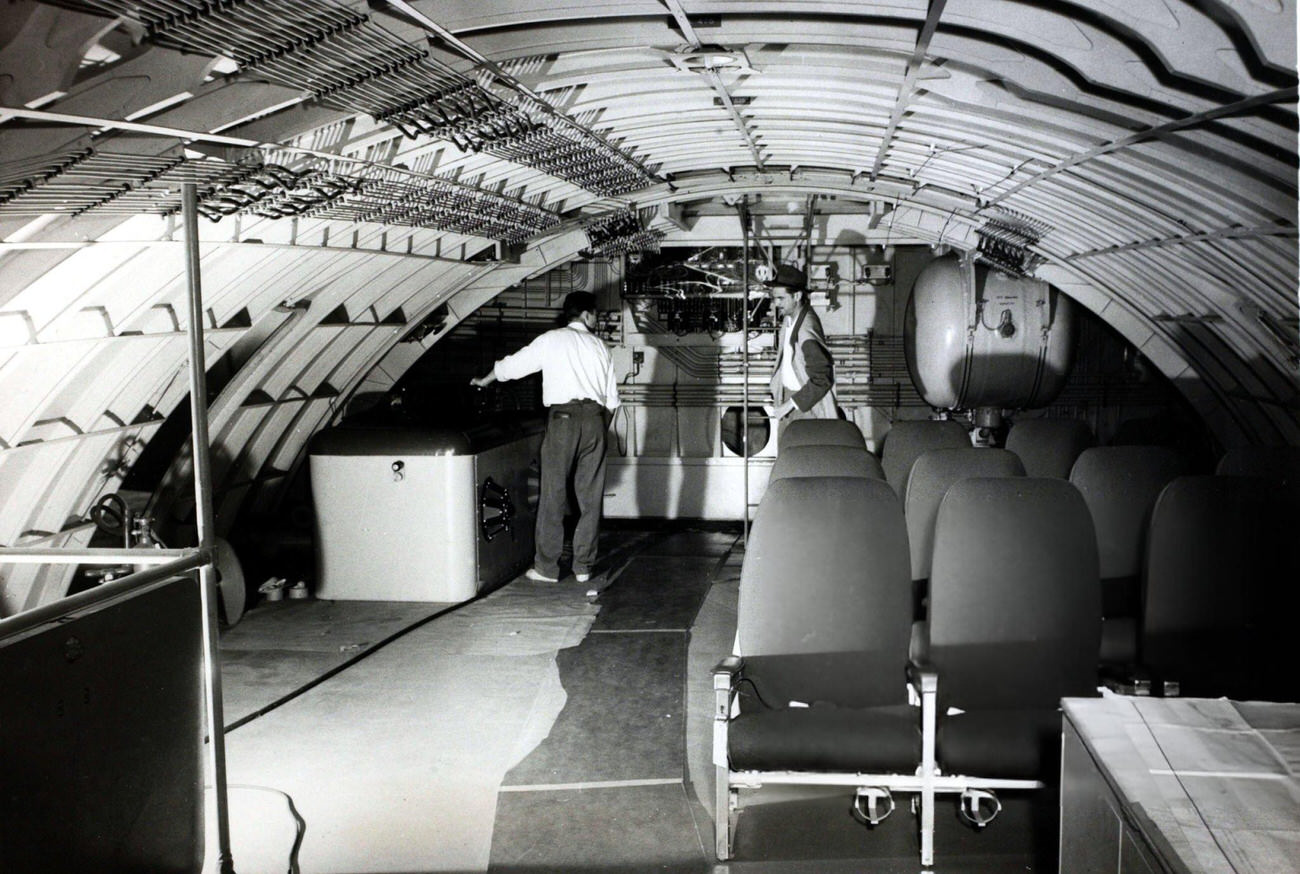 Howard Hughes on his Spruce Goose with an engineer, 1947.