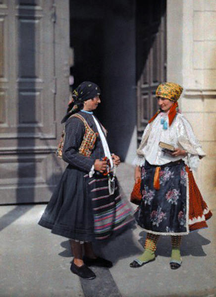 Two Serbian women in brightly colored clothes in Mohacs, Hungary, June 1932.