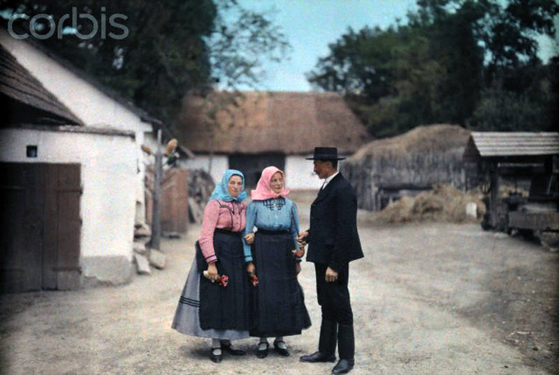 People in folk costume visit in a Hungarian village, January 1930.