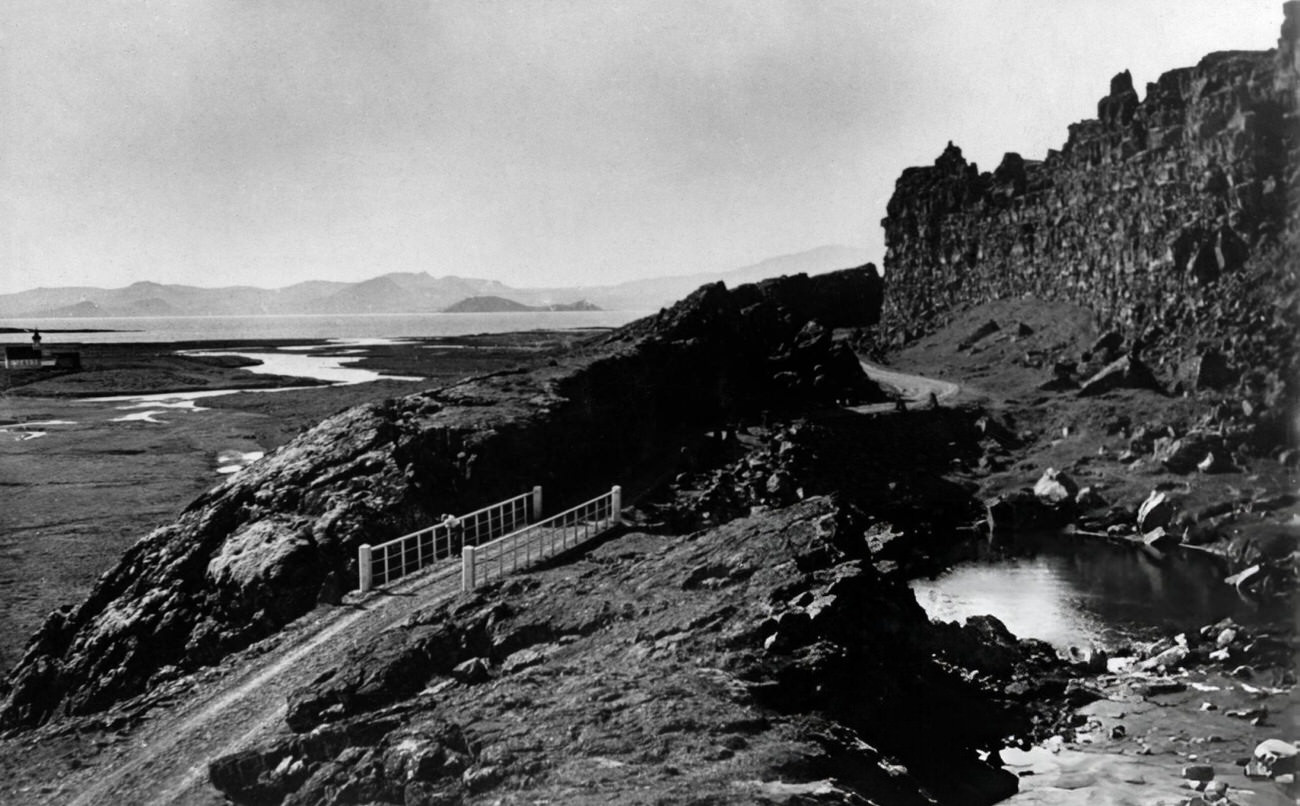 Landscape photograph with bridge and craggy rocks at Thingvellir, Iceland, 1930s.