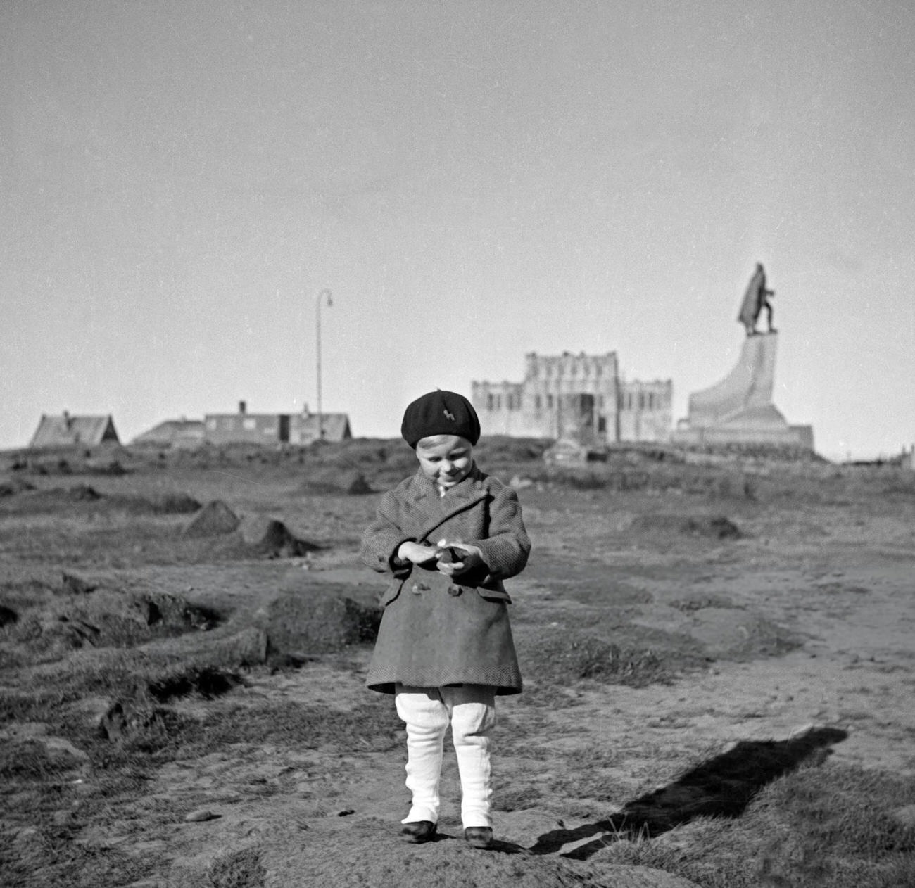 A young boy in front of the Ingolfur Arnarson statue in Reykjavik, Iceland, 1930s.