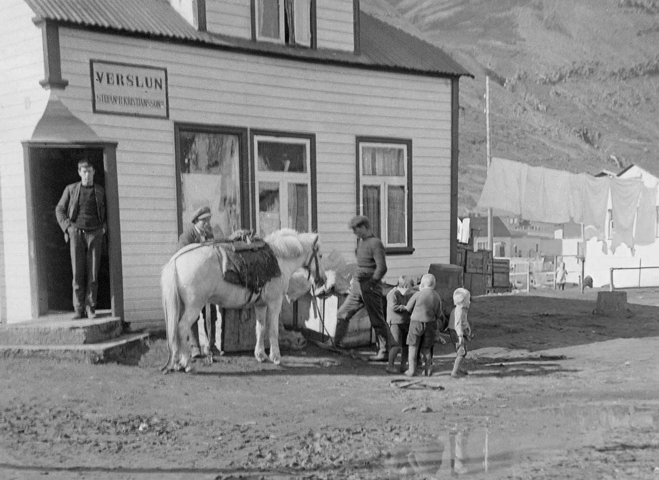 People with a horse outside an inn in Siglufjordur, Iceland, 1935.