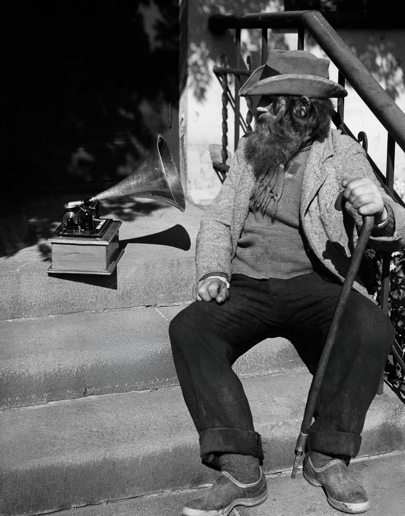 An old man sitting in front of a recorder in Reykjavik, Iceland, 1934.