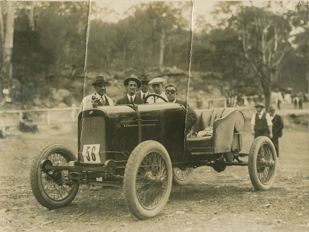 Don Harkness at the wheel of modified Overland car at race meeting