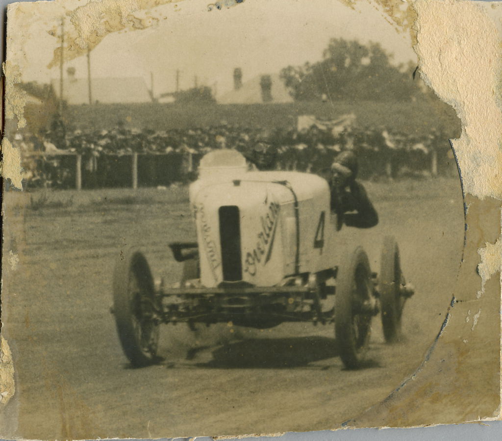 Don Harkness at the wheel of his Overland Sports car Whitey at race meeting