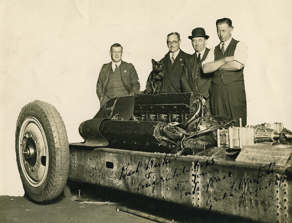 Group and a cat inspecting the car F.H. Stewart Enterprise