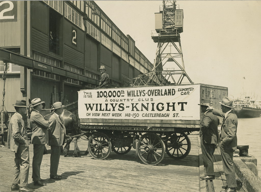 Horse and cart on wharf with crate containing the 100,000th Willys-Overland exported car, 1920 - 1929