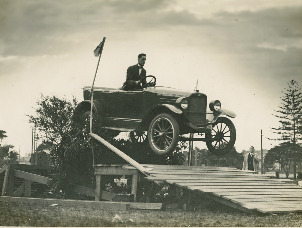 Overland car jumping a fallen bridge in a promotional stunt, 1920 - 1929