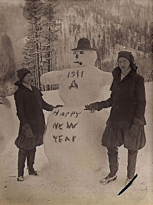 Two children with a snowman, greeting the New Year, 1911.