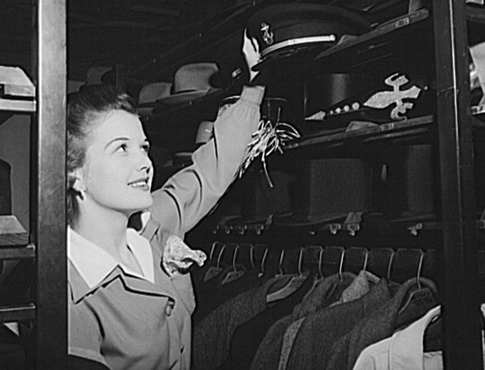 A partygoer taking soldiers' hats.