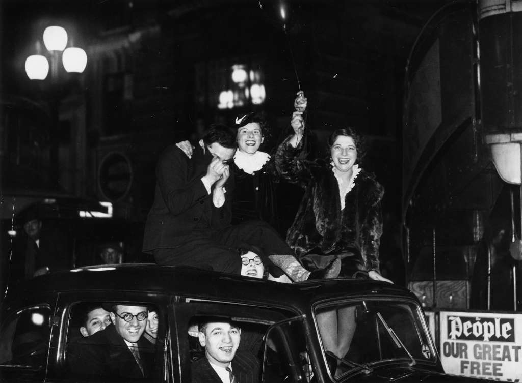 Friends celebrating the arrival of 1936 on a car roof in London.