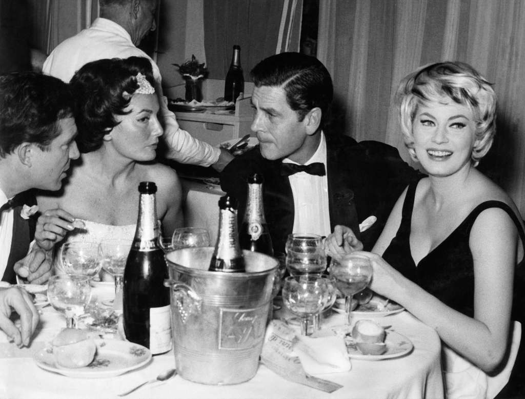 Ugo Tognazzi, Caprice Chantal, Anthony Steel, and Anita Ekberg at Saint Vincent Casino, Piedmont, on December 31, 1958.