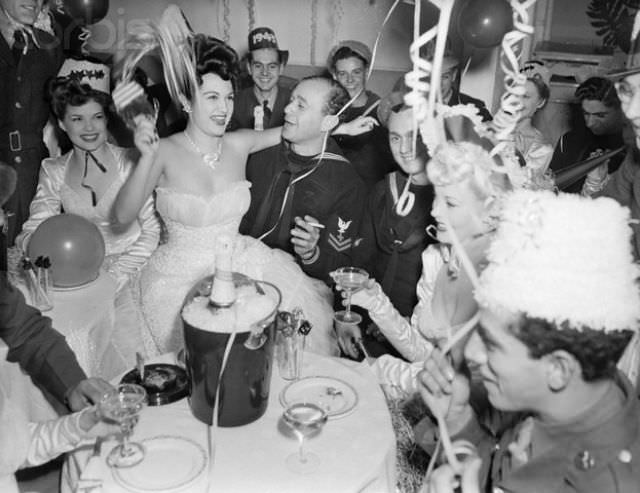 Showgirls celebrating New Year's Eve with soldiers and sailors, New York City, 1941.