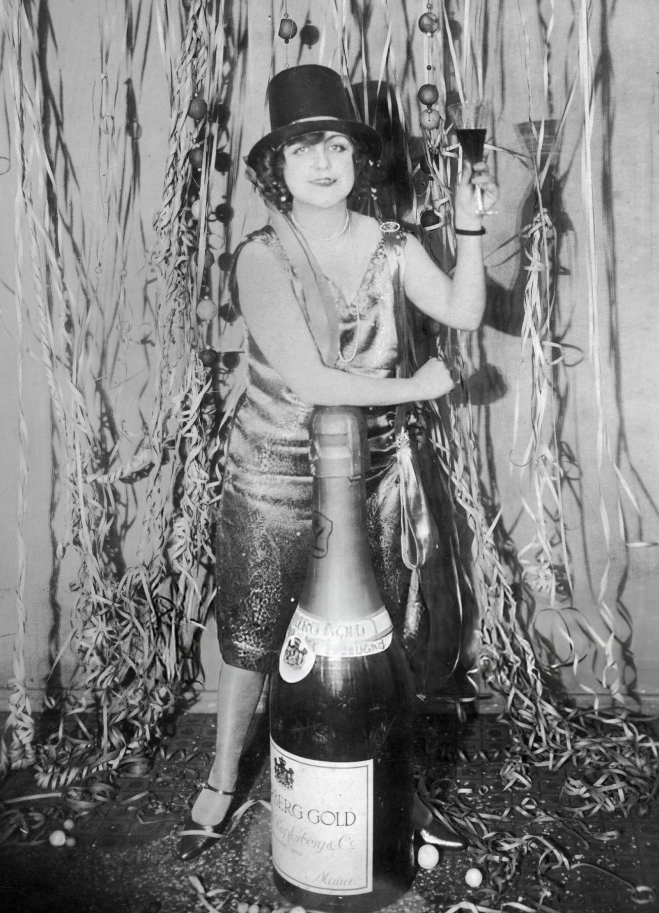 A woman toasting at a New Year's Eve party in Germany, 1925.