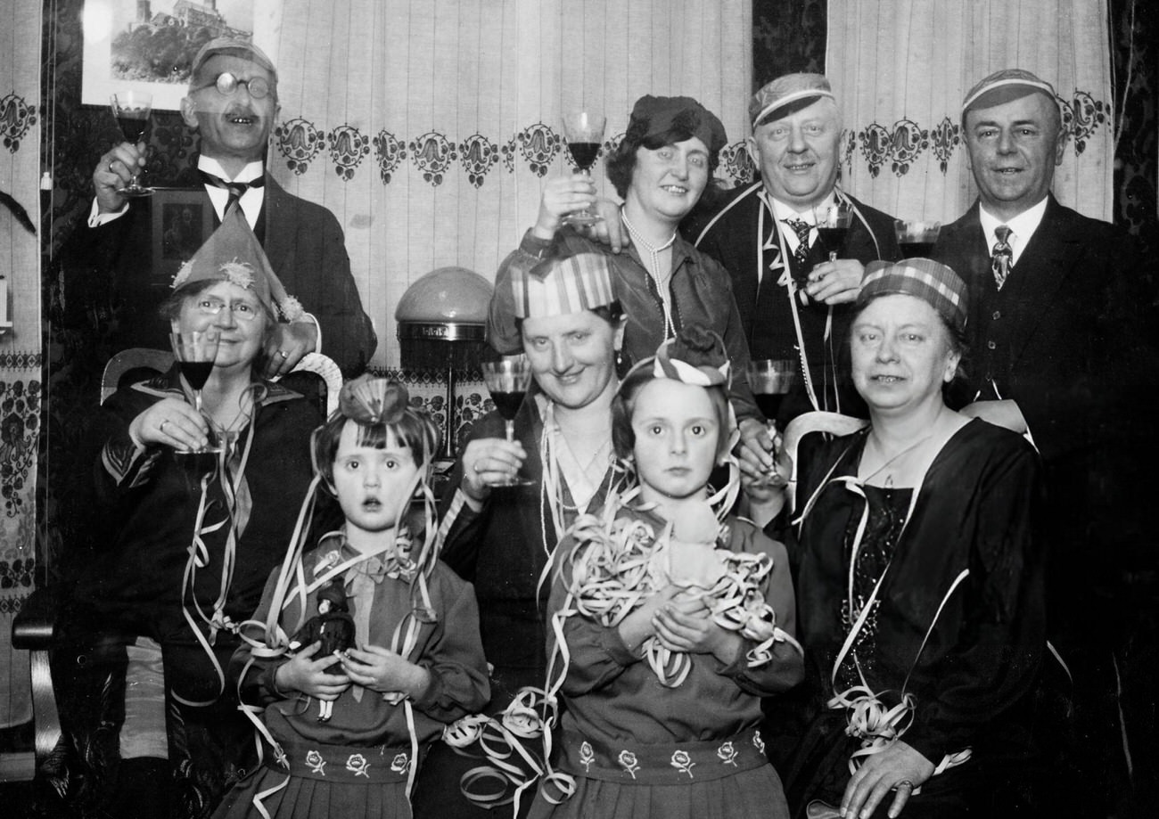 Adults and children celebrating New Year's Eve in Germany, 1927.