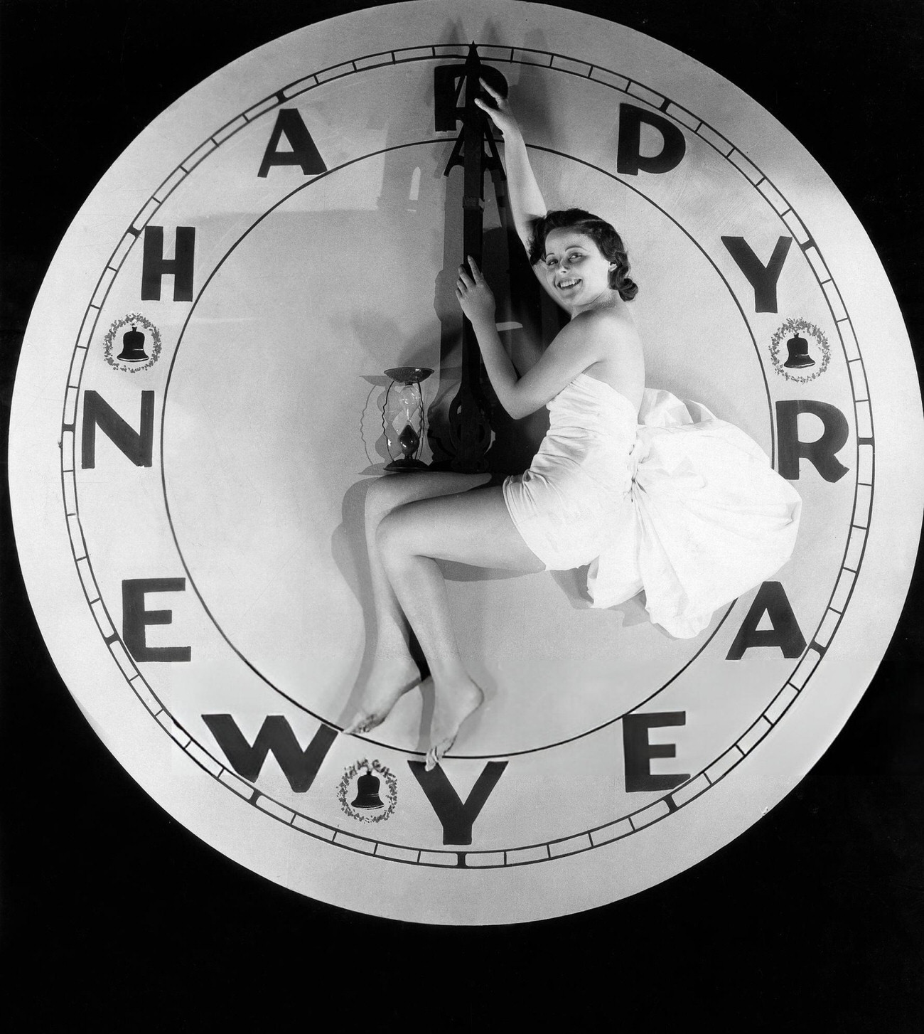 A woman sitting on a watch at twelve o'clock on New Year's Eve, 1928.