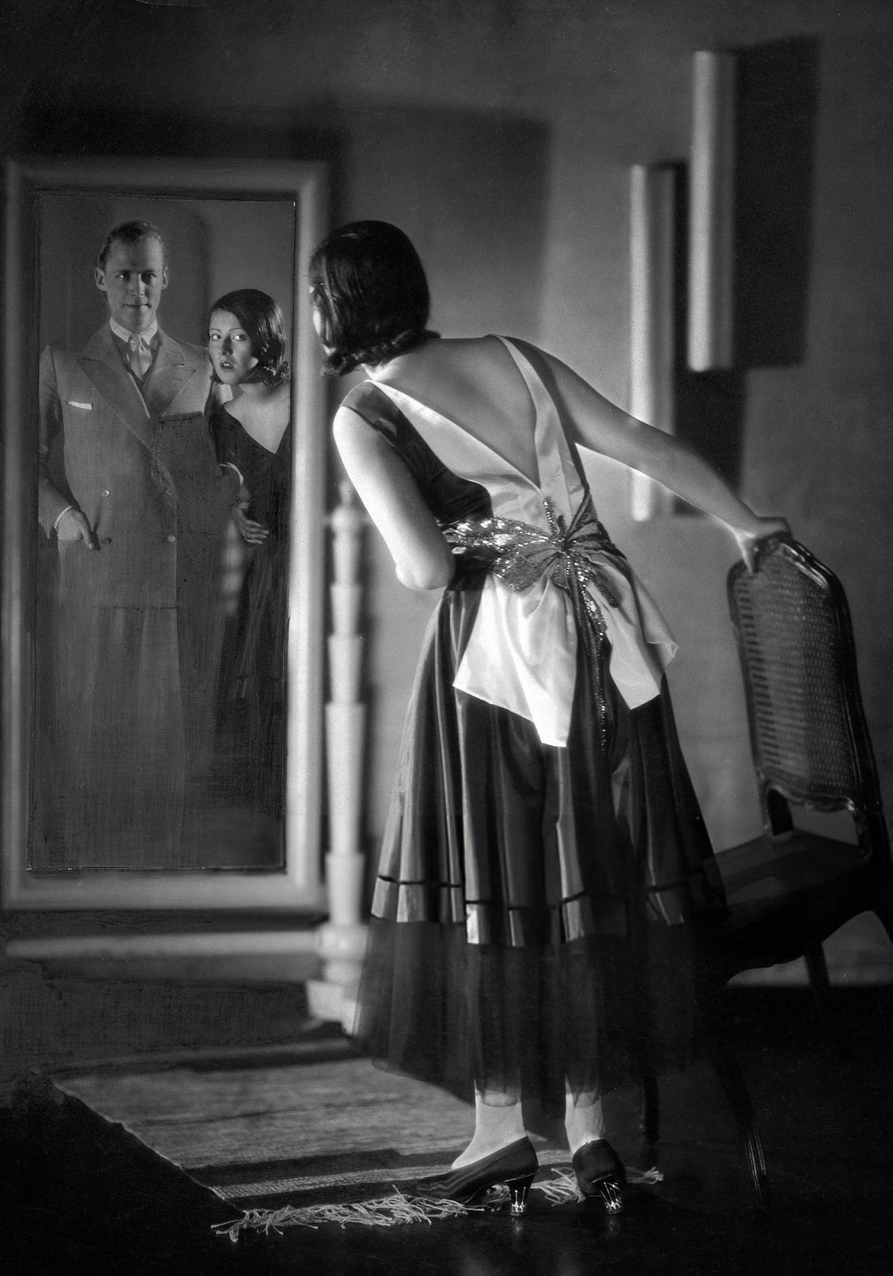 A woman looking in a mirror on New Year's Eve, 1929.