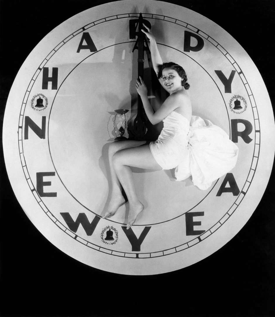 A woman sitting on a watch at twelve o'clock on New Year's Eve, 1928.