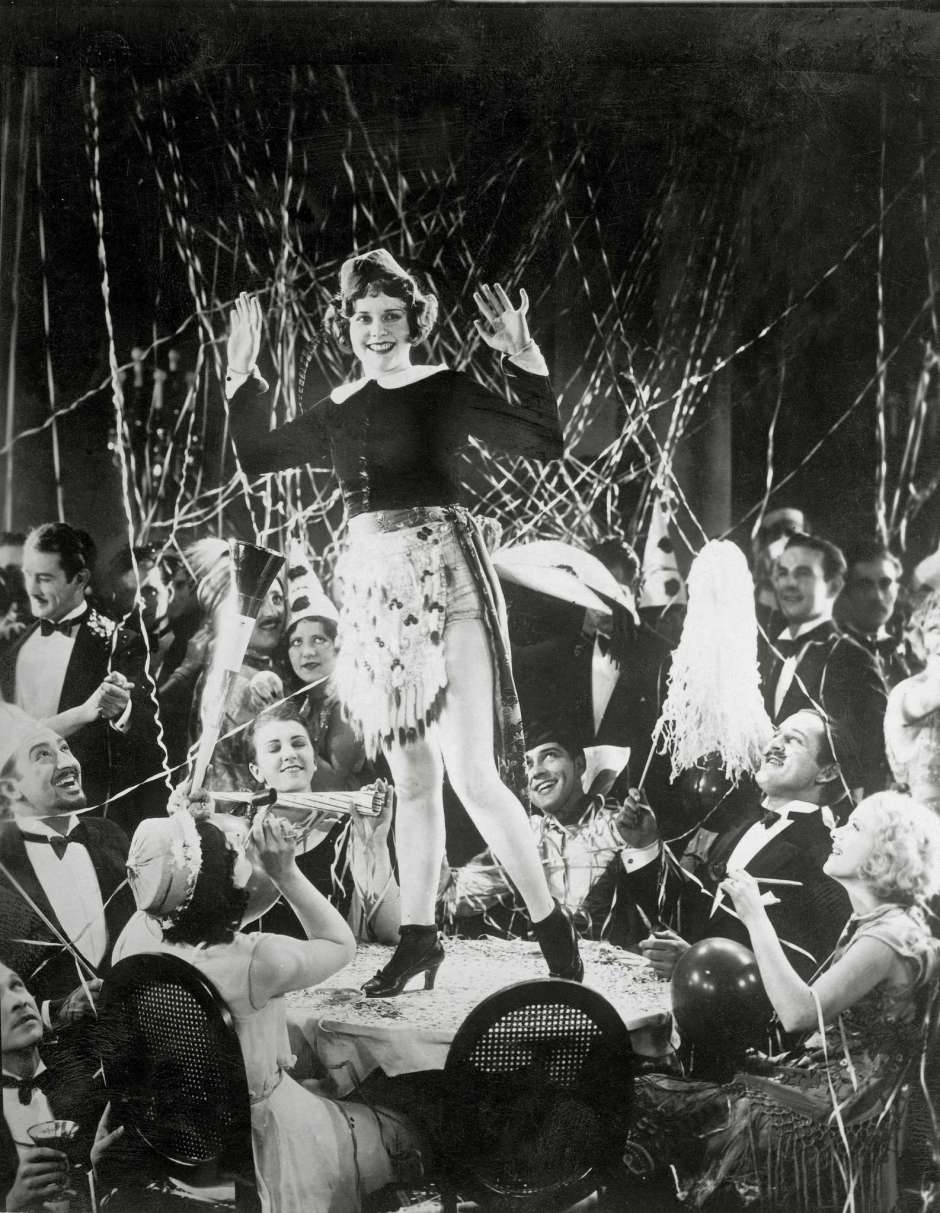 A girl dancing on a table at a New Year's party in Hollywood, 1930s.