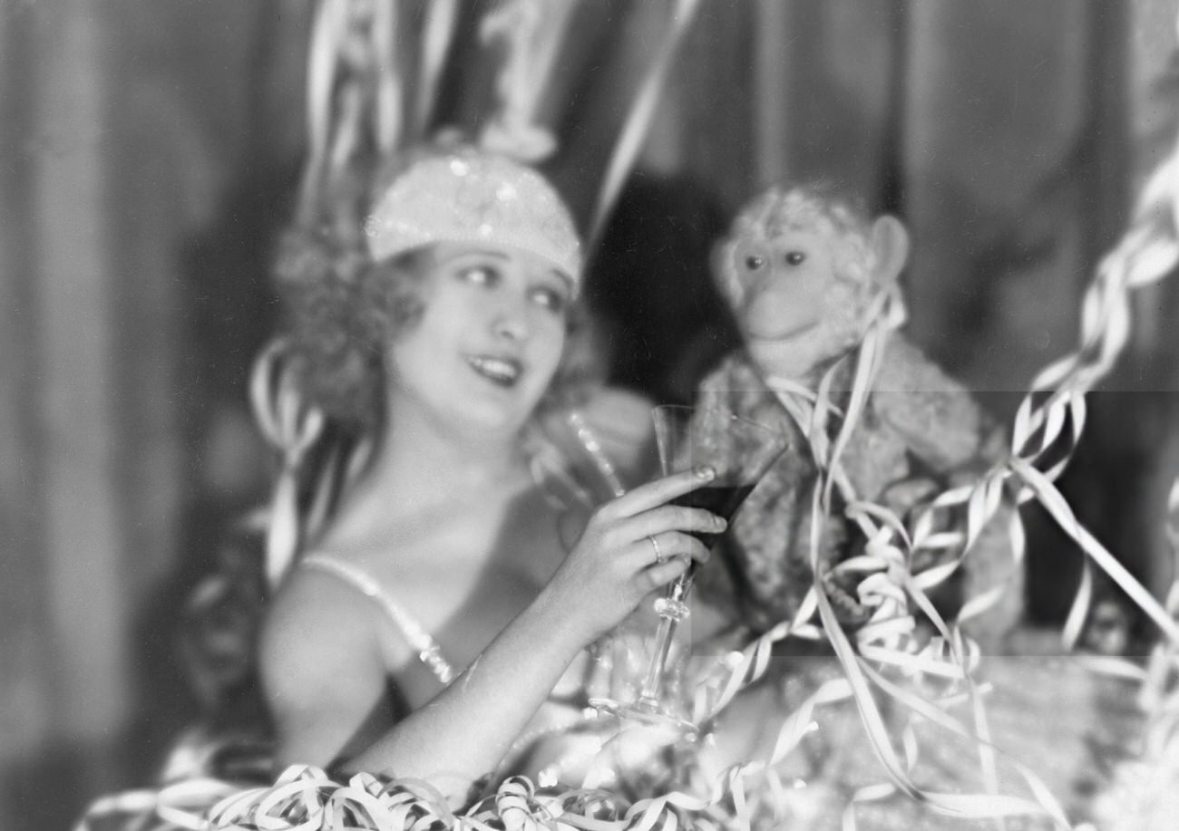 Lee Parvy toasting with a plush monkey on New Year's Eve, 1927.