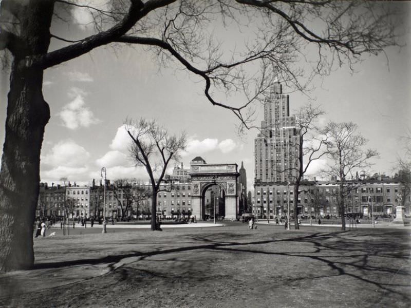 Looking north in Washington Square, fountain, arch, 1 Fifth Avenue and in the distance, the Empire State building.