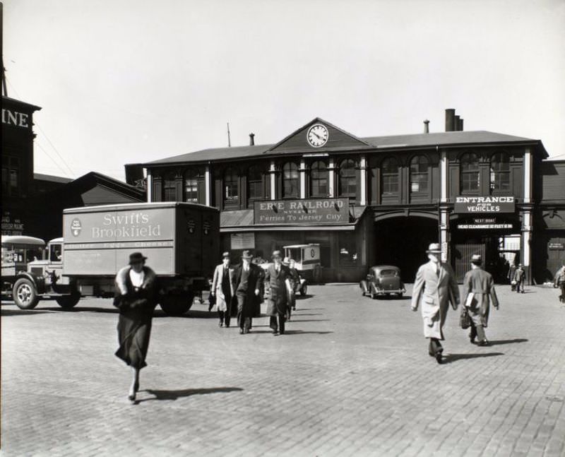 Ferry, Chambers Street, Manhattan. Trucks, wagon, car and pedestrians in front of Erie Railroad ferry terminal.