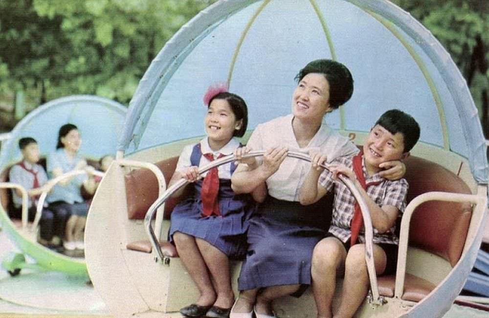 A family enjoys a ride at the Taesongsan Funfair, which is located close to Pyongyang and is still open today. The park is named for Mount Taesong, which it sits at the base of.