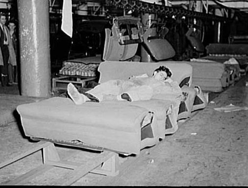 Napping on an auto seat assembly line in Flint, Michigan, 1937.