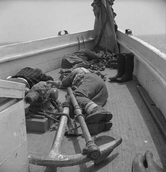 Gloucester, Massachusetts fishermen napping on deck, 1943.