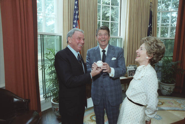 Ronald and Nancy Reagan receiving a baseball from Frank Sinatra