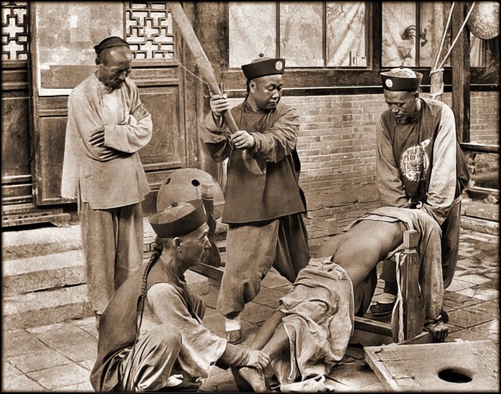 Chinese punishment: whipping a lawbreaker, 1900.