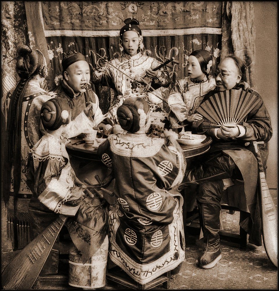 Rich merchants dining with singing girls, Peking, 1901.